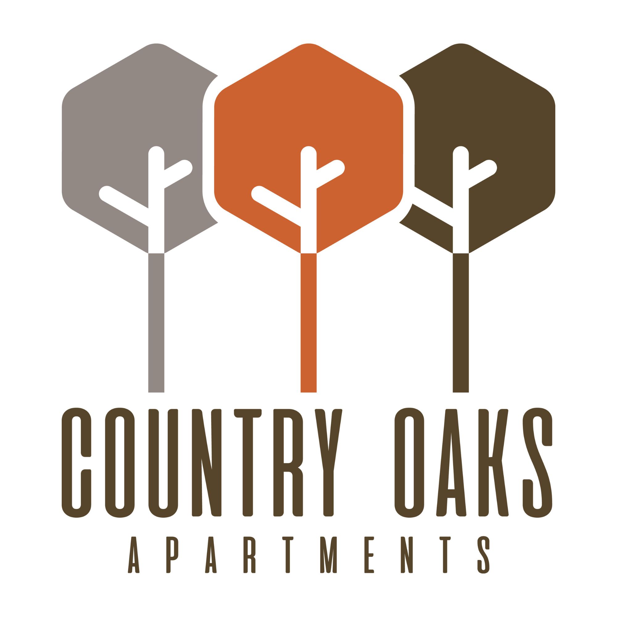 The image is a logo for Country Oaks Apartments, featuring three stylized trees in different colors.
